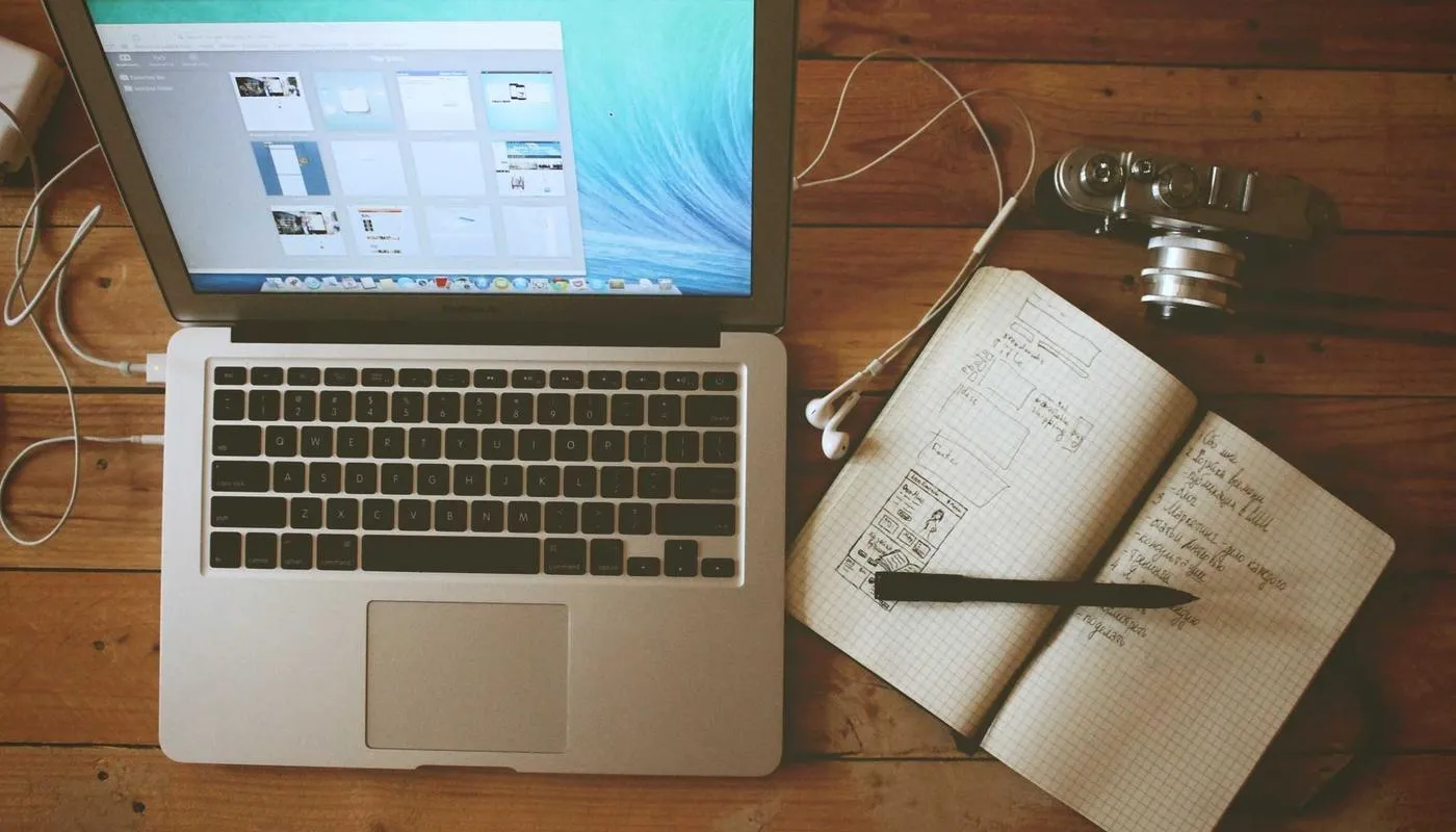 Laptop and notebook on a desk