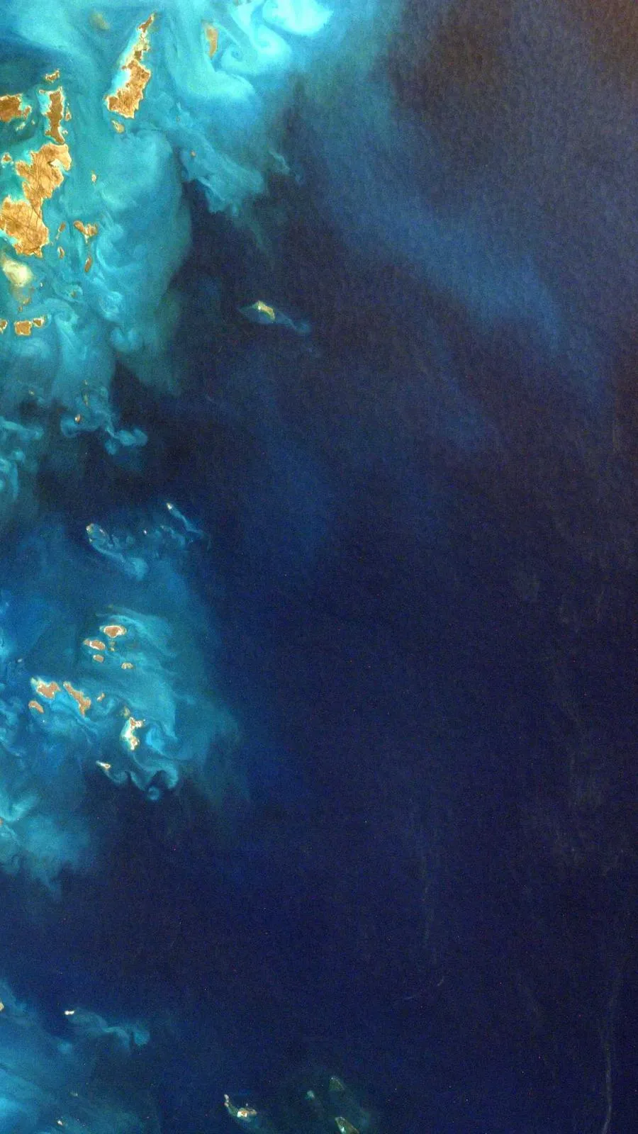 Aerial view of water meeting sand